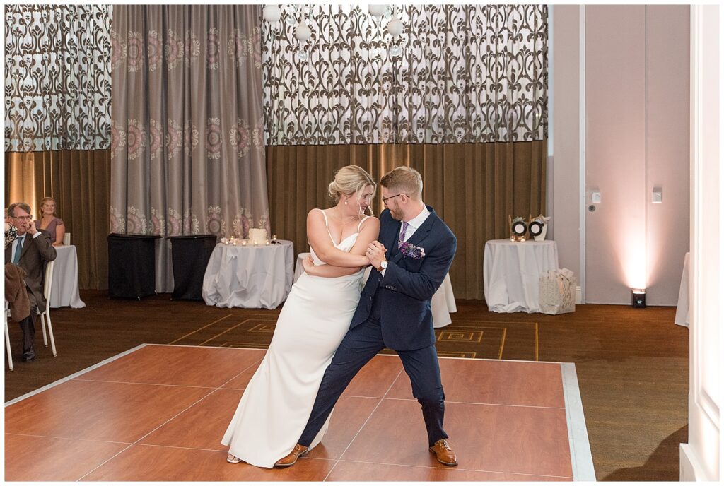 bride leaning hard against the right side of groom during fancy dance routine during the first dance at hotel monaco