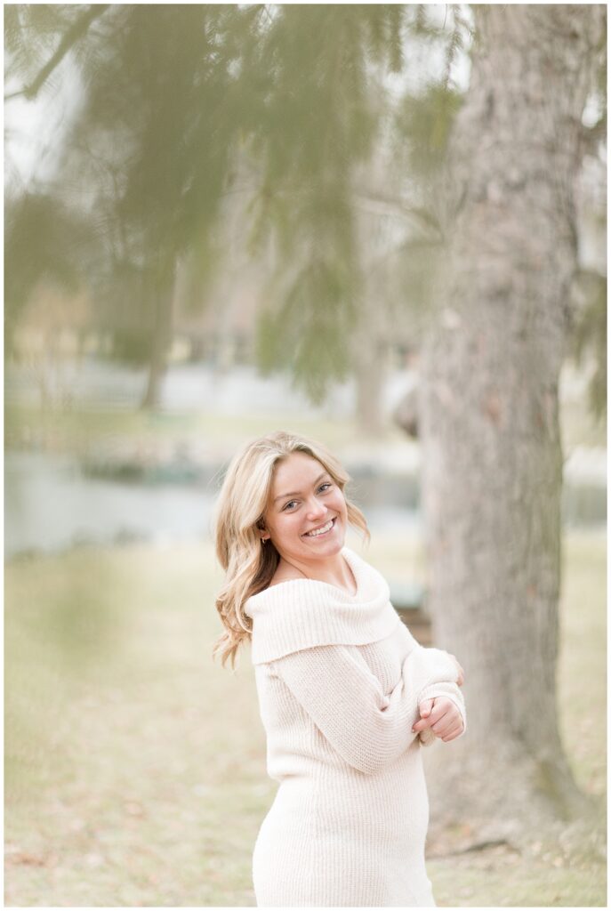 senior girl in looking over right shoulder by tree at longs park in lancaster pennsylvania