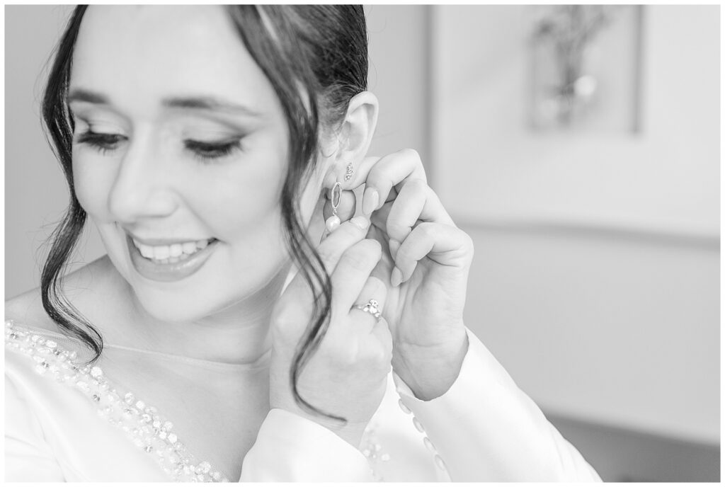 closeup black and white photo of bride putting in her left earring in adamstown pennsylvania