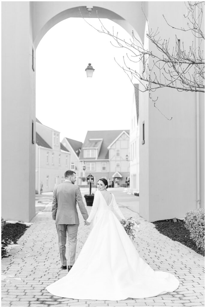 black and white photo of couple holding hands with bride facing front and groom facing back in lancaster county pennsylvania