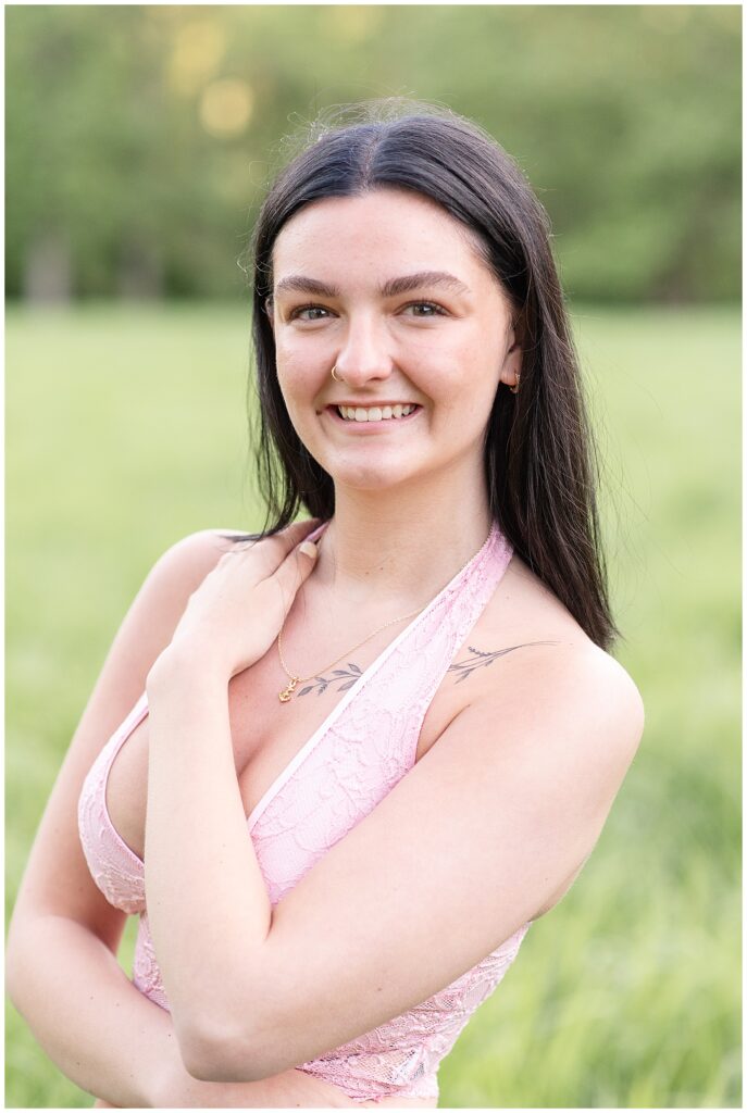 closeup photo of senior girl with her left hand touching her right shoulder at hibernia park