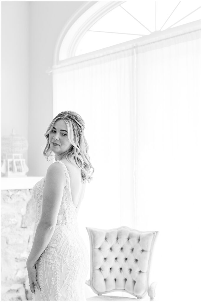 black and white photo of bride looking back over her left shoulder in bridal suite for this Bryn Awel Manor Summer Wedding