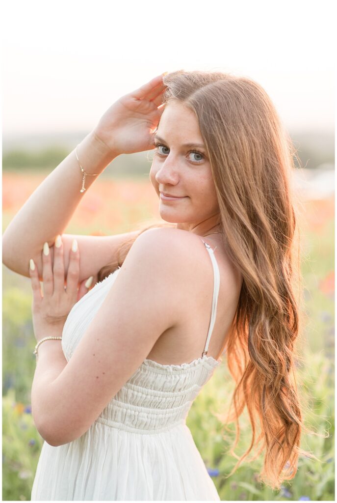 close up photo of senior girl's looking over left shoulder for this wildflower field summer senior session