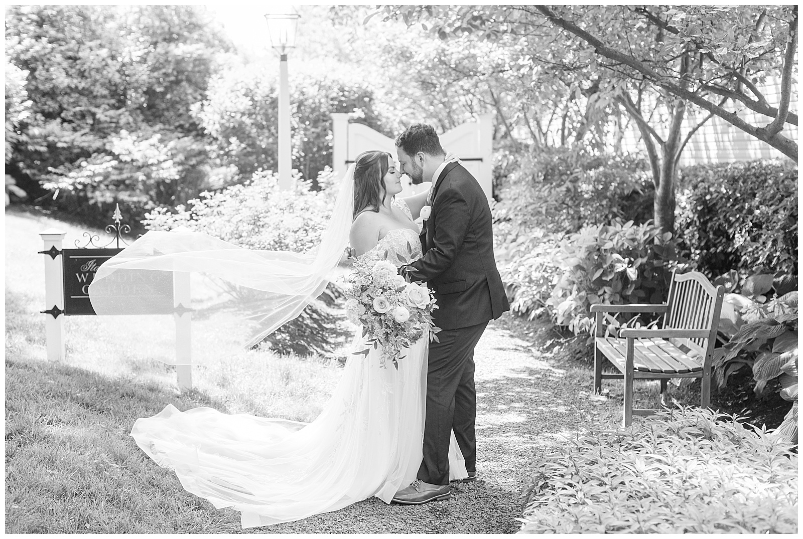 black and white photo of bride and groom touching noses outside for this Inn at Leola Village Wedding