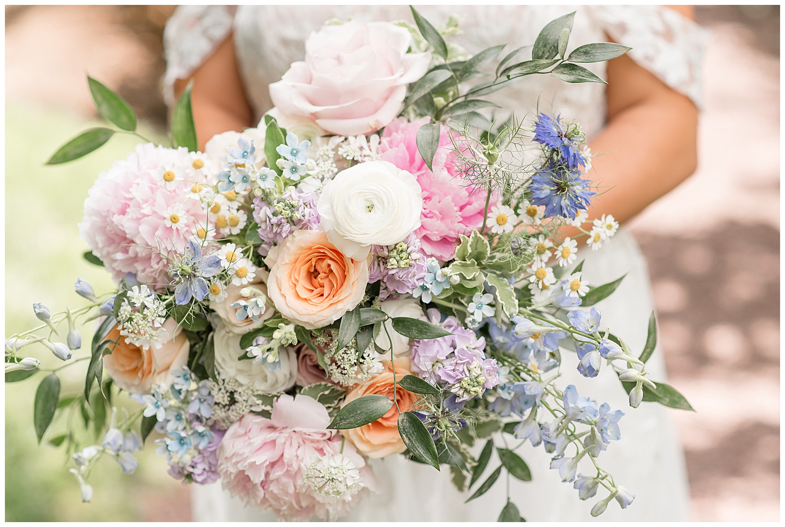 stunning bridal bouquet filled with pink, purple, white, blue, and orange roses, daisies, peonies and more for Inn at Leola Village Wedding