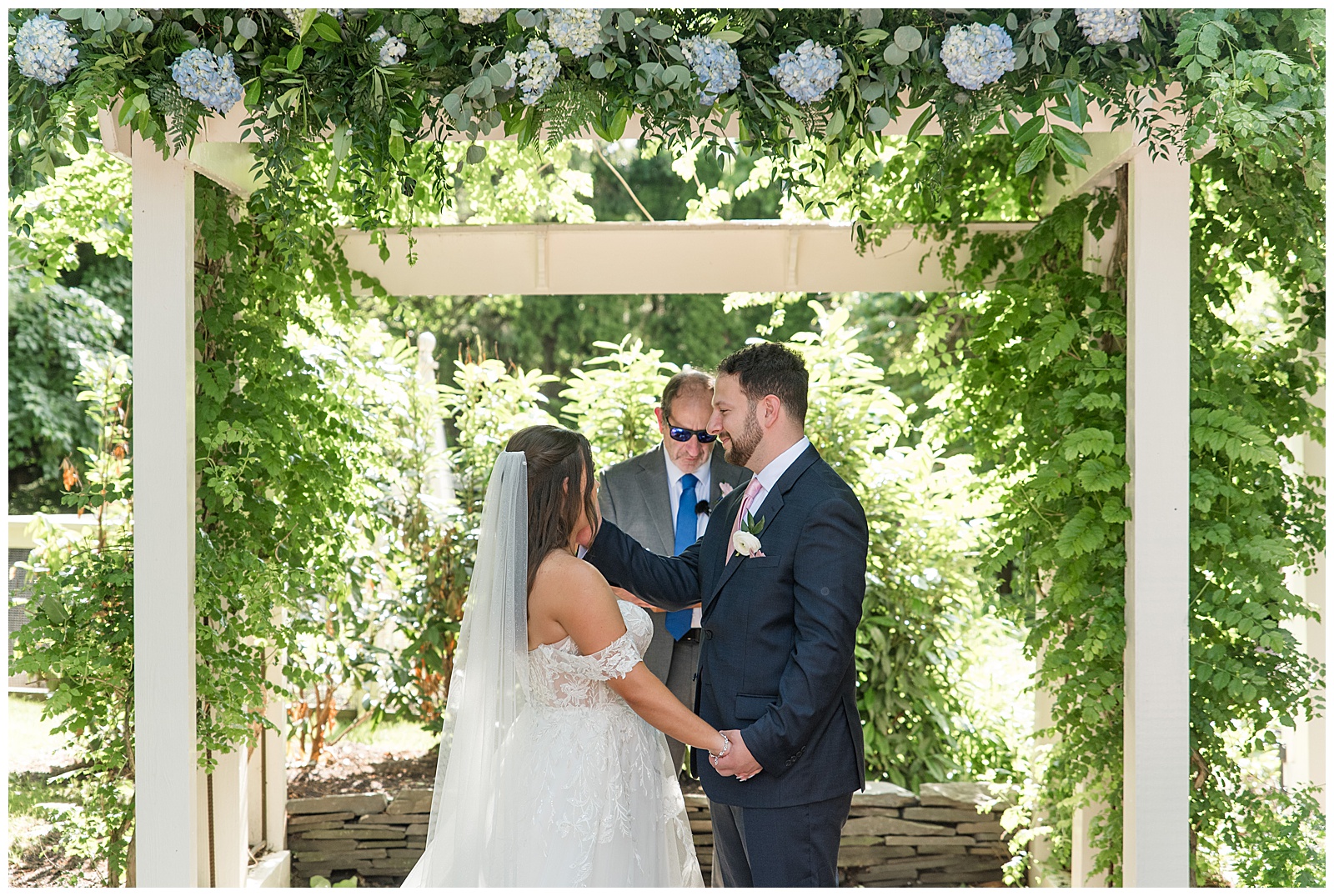 couple holding hands during outdoor wedding ceremony in lancaster county pennsylvania