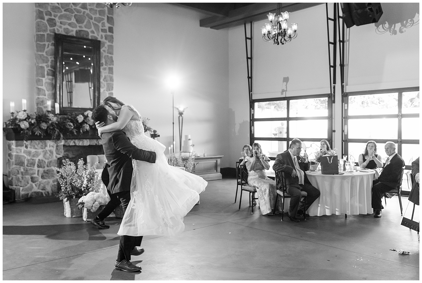 black and white photo of groom lifting his bride during their dance at this lancaster county wedding