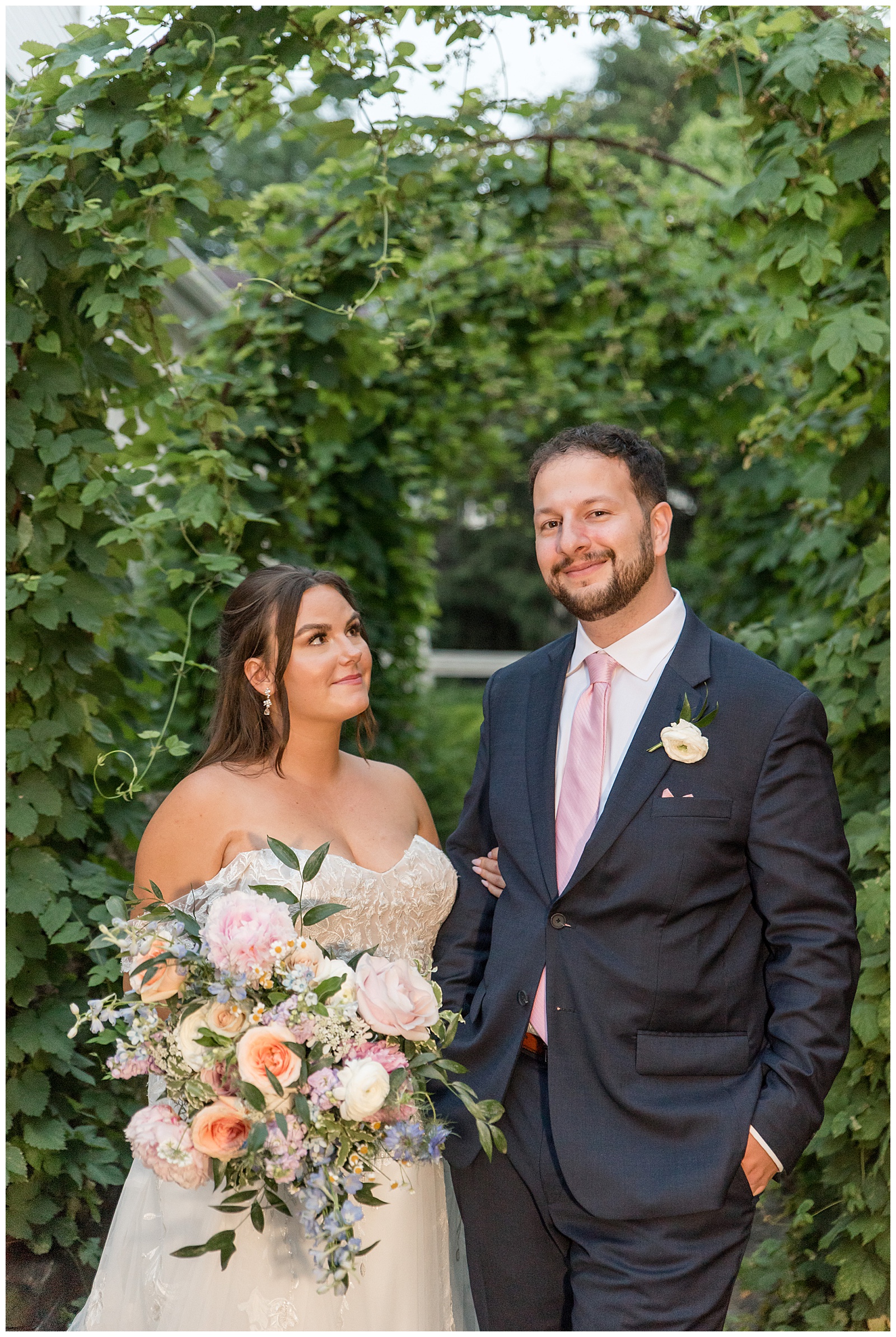 bride looking up at her groom as he smiles at the camera at this Inn at Leola Village Wedding