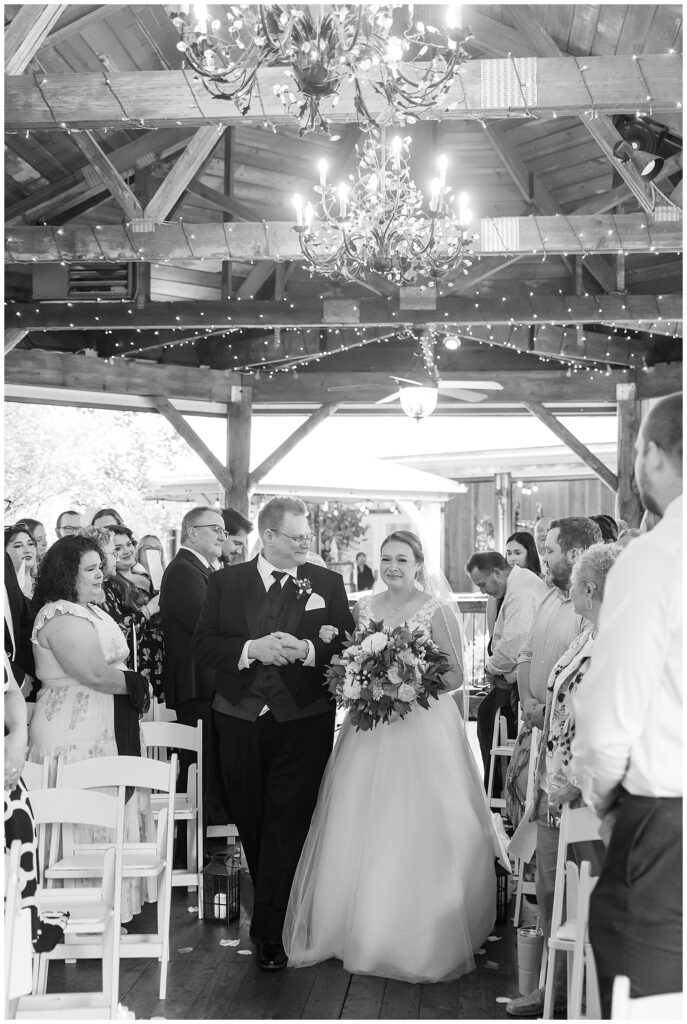 bride walking down aisle with dad for summer riverdale manor wedding