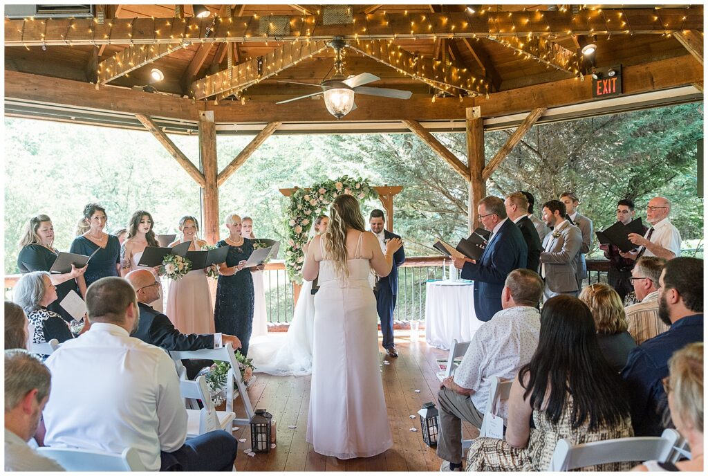 surprise song for bride and groom sung by bridal party and family during ceremony