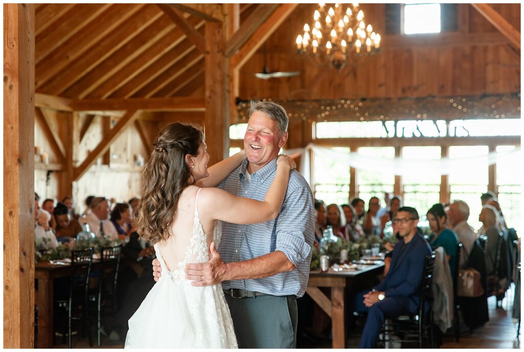 bride and groom sharing their first dance at barn wedding reception at this Lakeview Farms Summer Wedding