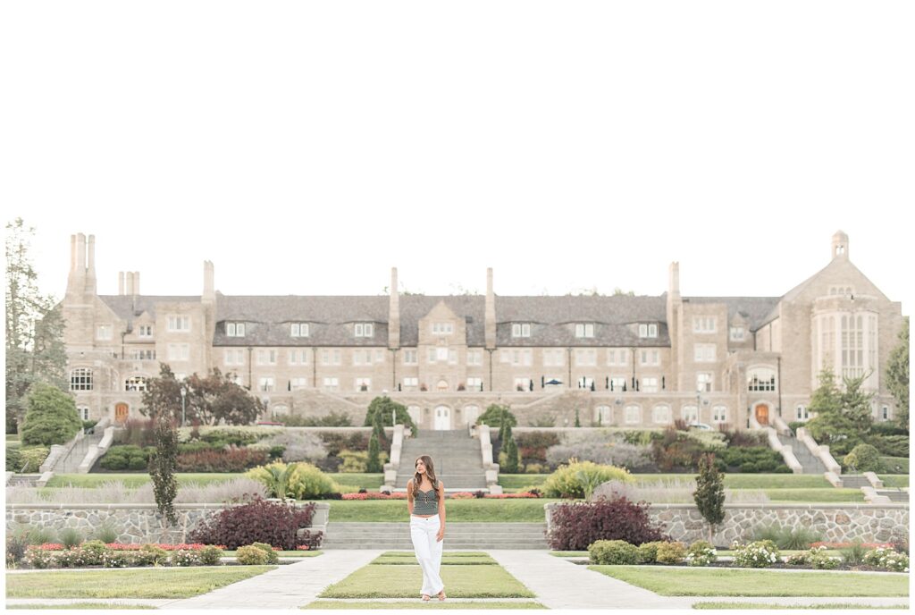 senior girl looking right with majestic building in background at this Summer Masonic Village Senior Session
