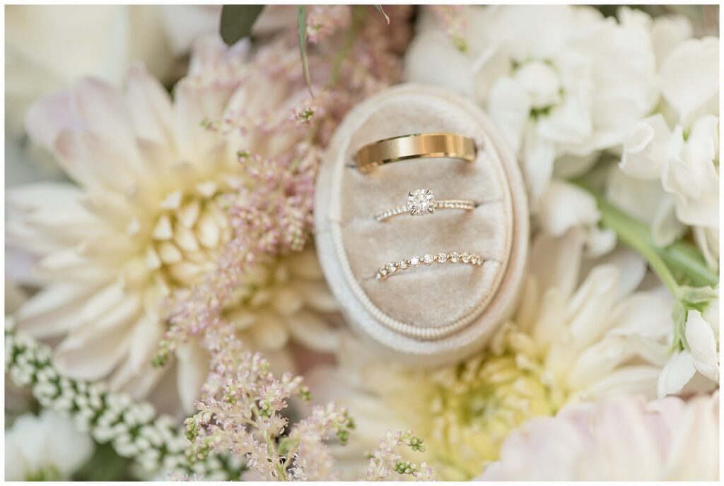 wedding rings displayed in oval box atop white dahlias for this Elizabeth Furnace Fall Wedding