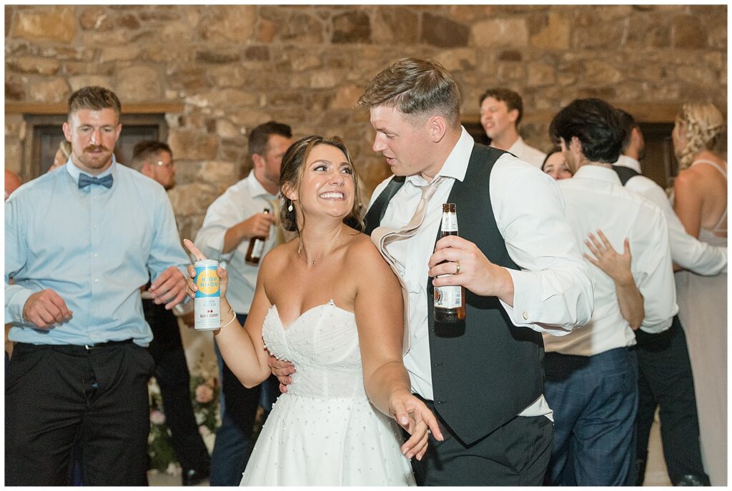 couple smiling and dancing with guests during reception for this Elizabeth Furnace Fall Wedding