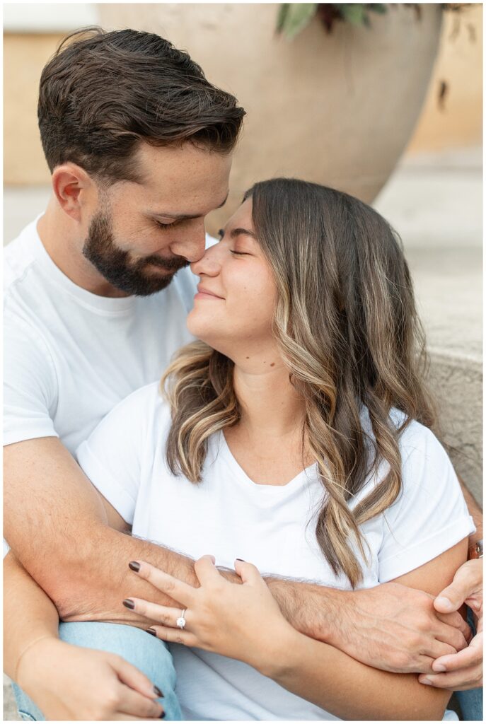 couple sitting close on steps and touching noses for this Fall Hibernia Park Engagement Session