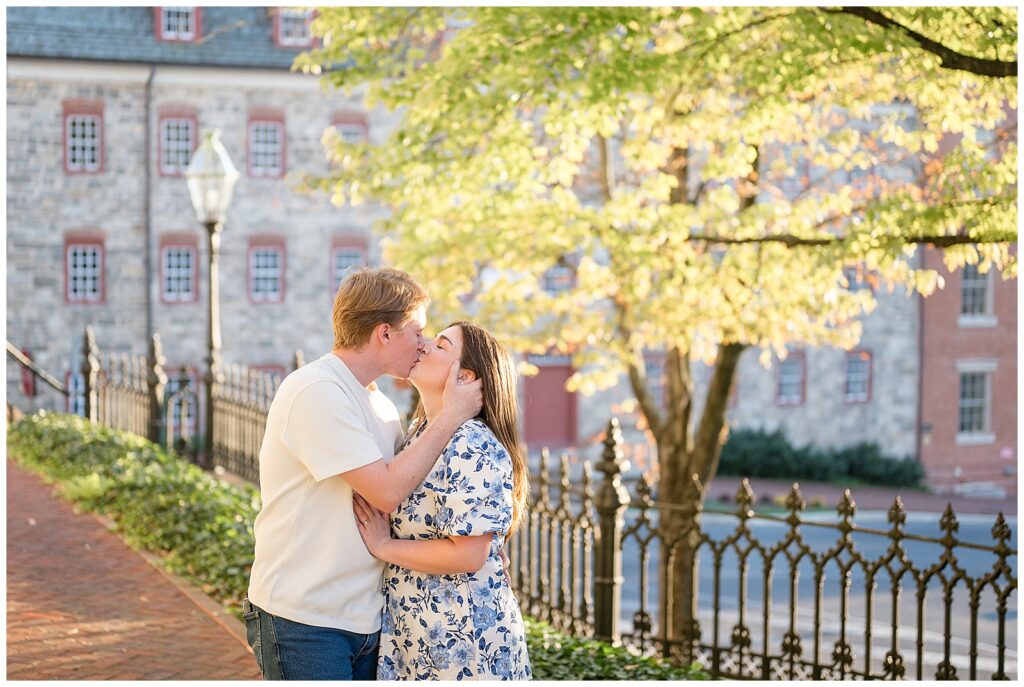 couple kissing at sunset by historic building for this Downtown Bethlehem Engagement Session