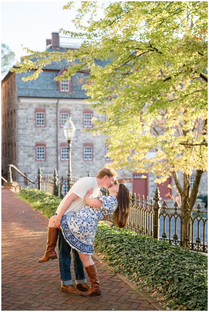 man dipping woman back as they kiss on brick pathway for this Downtown Bethlehem Engagement Session