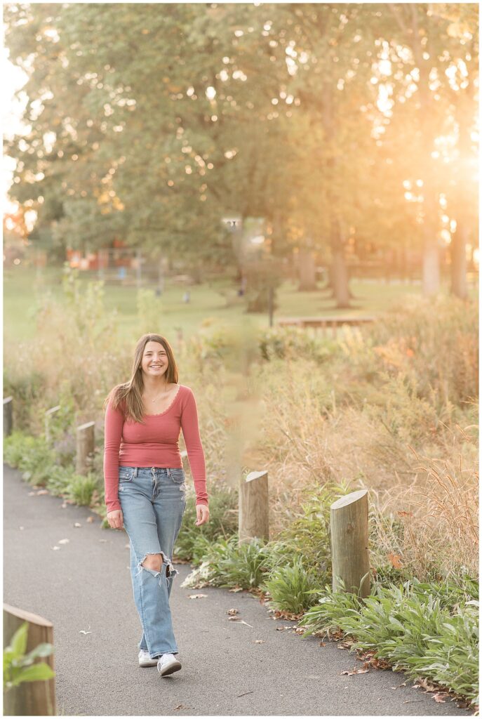 senior girl walking along pathway for this Longs Park Fall Senior Session