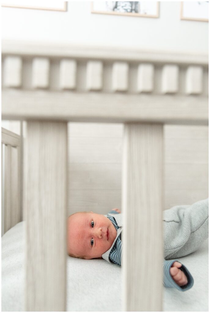 baby boy laying in his white crib for this in-home newborn session in central pennsylvania