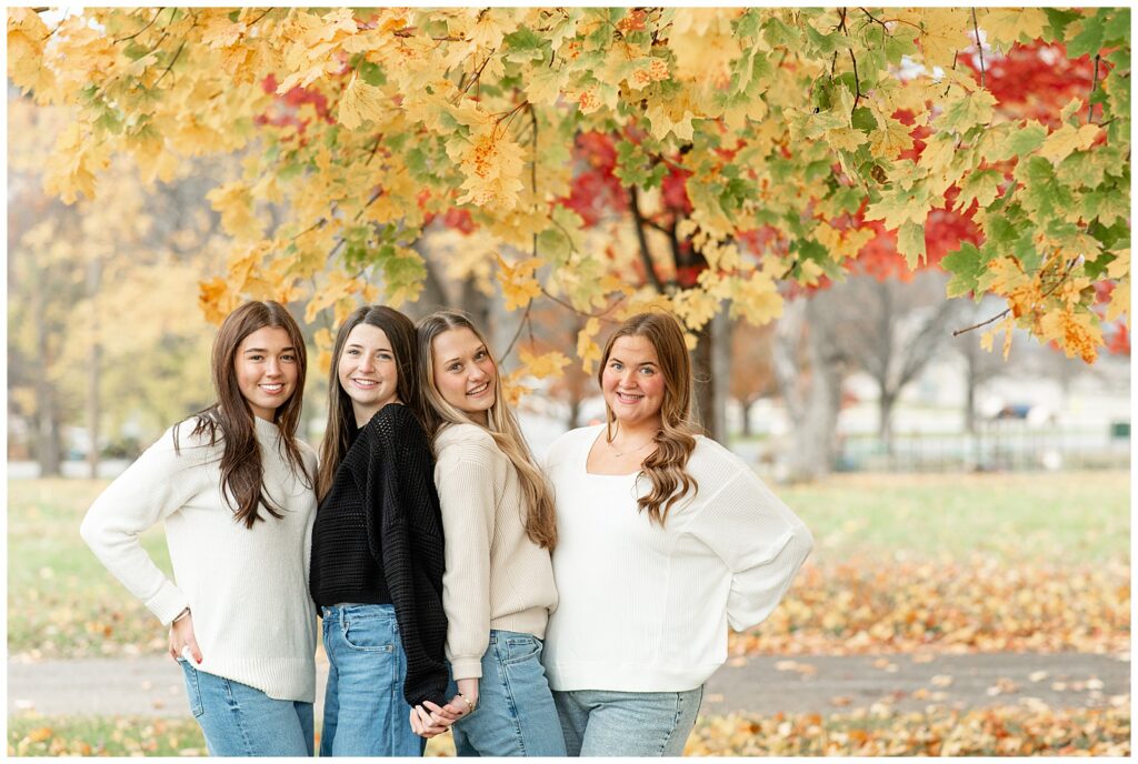 senior girls in cozy sweaters and blue jeans standing together for this Fall Senior Team Session in York PA