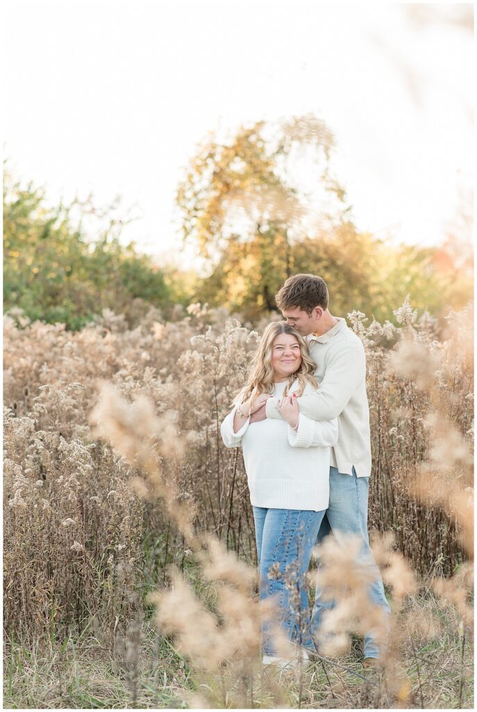 guy standing behind girl as he kisses the top of her head for this Overlook Park Fall Engagement Session