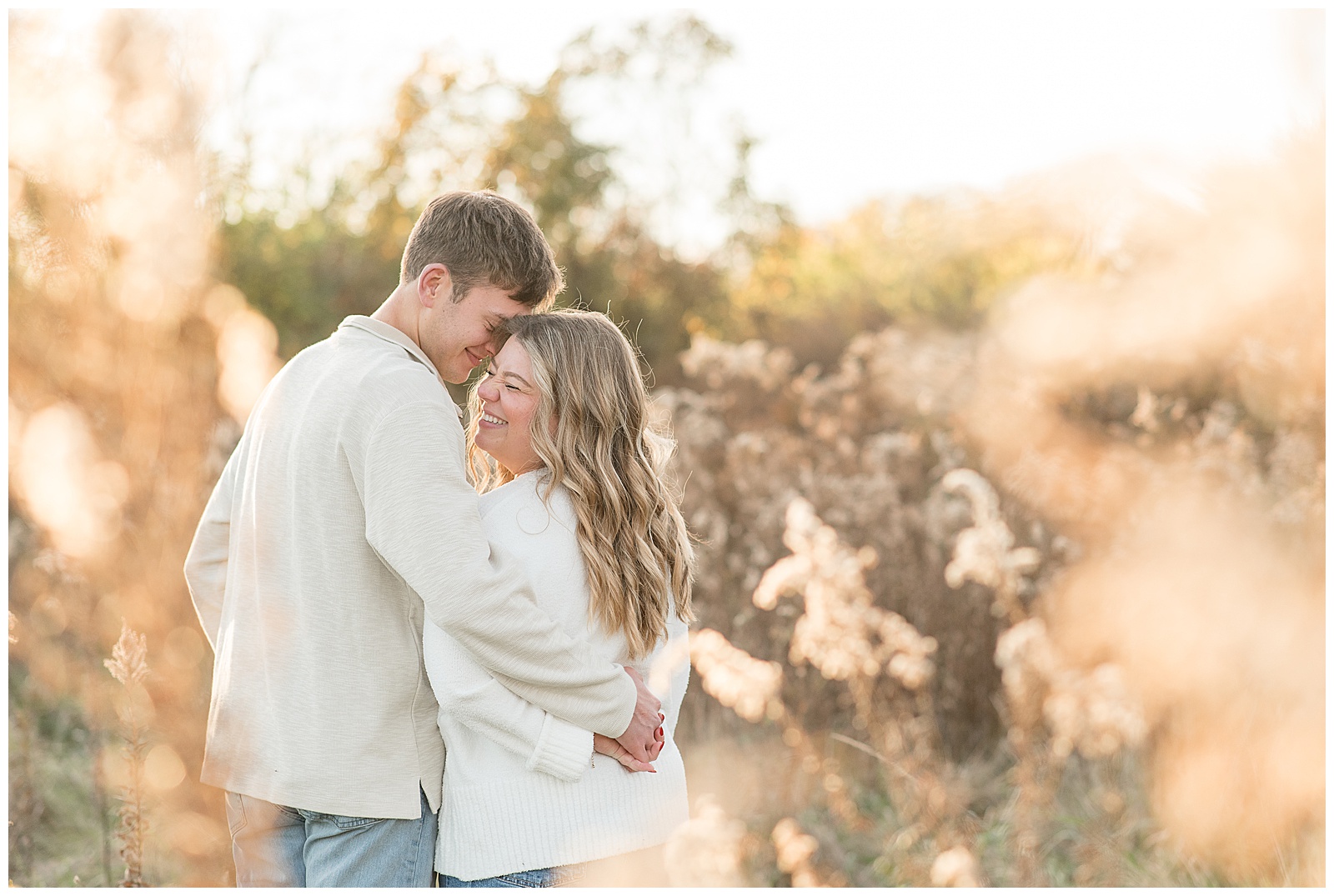 couple hugging at sunset on beautiful fall day for this Overlook Park Fall Engagement Session