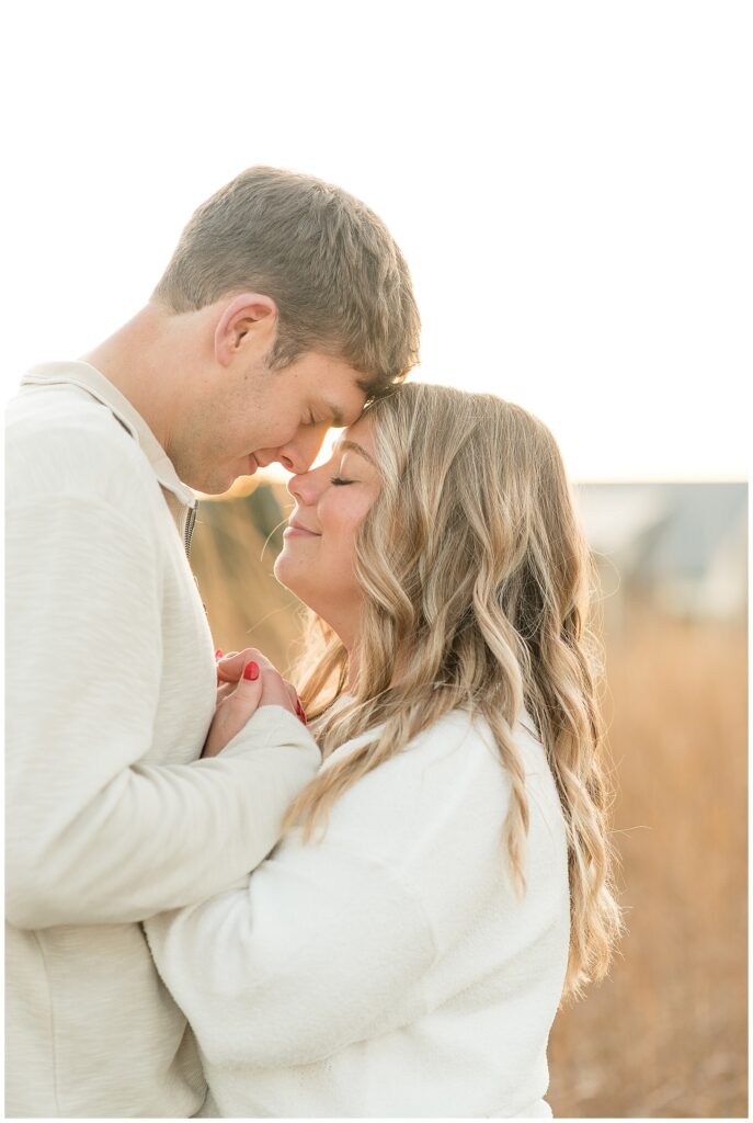 engaged couple standing close with foreheads touching in intimate moment for this Overlook Park Fall Engagement Session