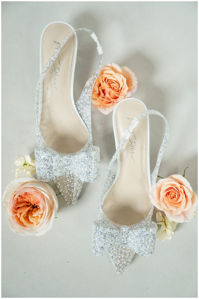 silver sparkly high heels surrounded by orange flowers for this Barn at Silverstone Fall Wedding