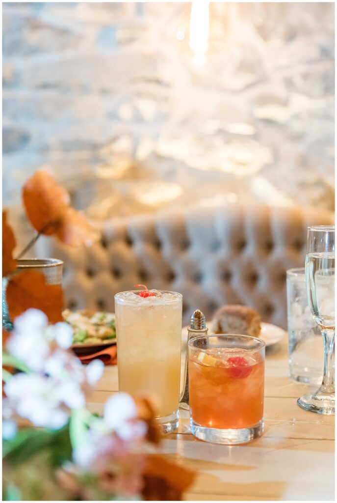 stunning couples table at indoor barn reception for this Barn at Silverstone Fall Wedding