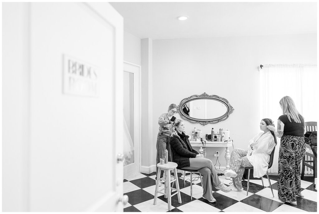 black and white image of bride getting hair and makeup done for this Wedding at The Rotunda at Lauxmont Farms