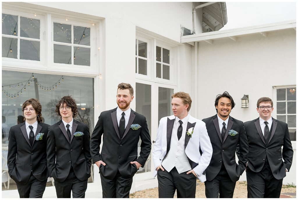 groom and his five groomsmen all walking toward camera outside with their hands in their pockets for this Wedding at The Rotunda at Lauxmont Farms