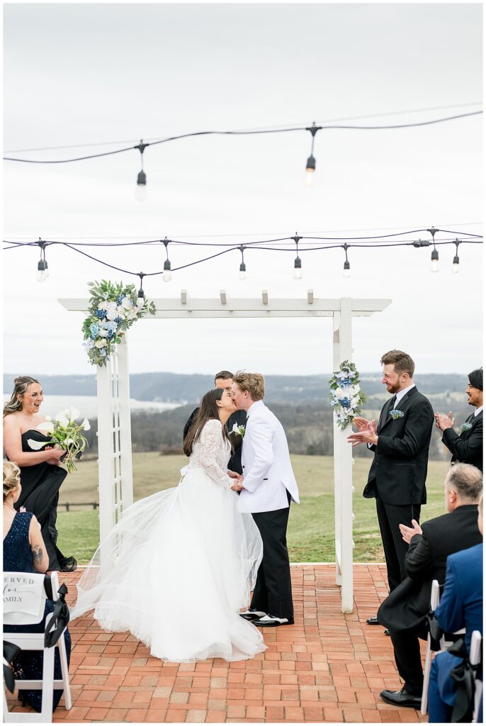 bride and groom share their first kiss at outside ceremony for this Wedding at The Rotunda at Lauxmont Farms
