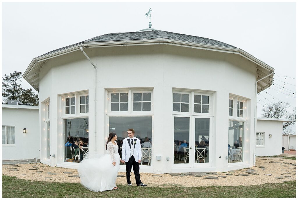 couple standing outside round white building for this Wedding at The Rotunda at Lauxmont Farms