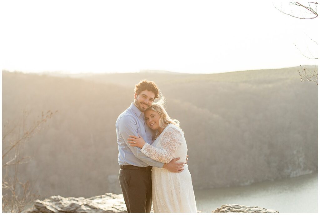 couple hugging as woman lays her head on man's chest for this Pinnacle Point Spring Engagement Session