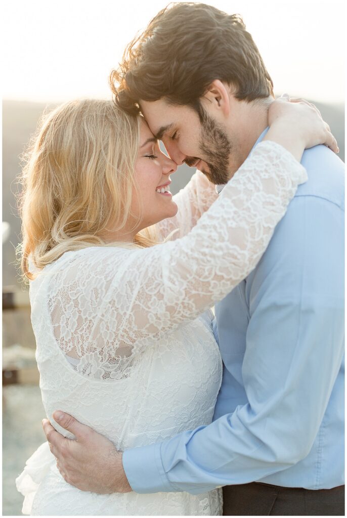 engaged couple with their foreheads touching as they hug for this Pinnacle Point Spring Engagement Session