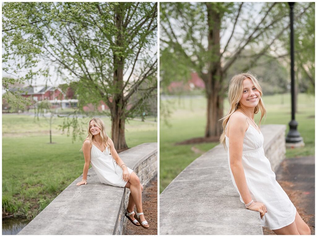 high school senior in white dress sitting along bridge