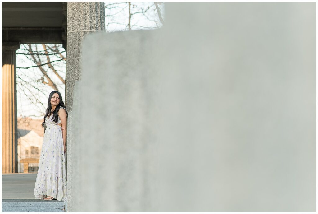 senior girl standing against long concrete wall for this Spring Masonic Village Senior Session