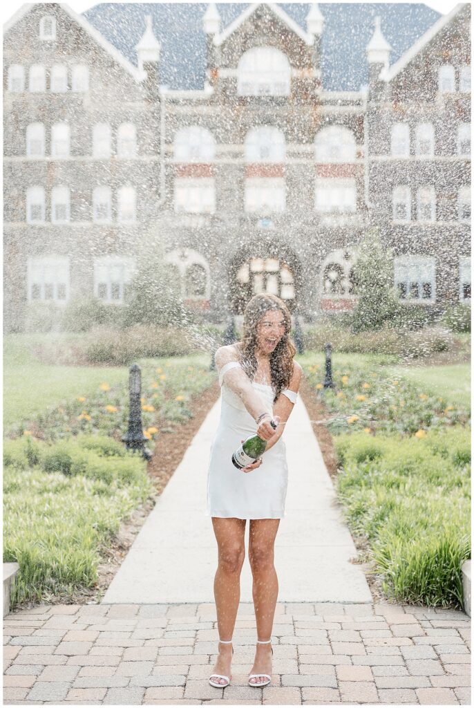 Moravian University graduate popping champagne bottle