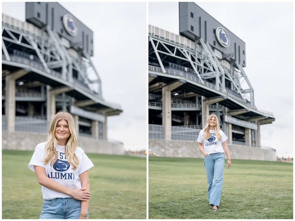 Beaver Stadium behind girl Penn State graduate walking towards camera in white alumni shirt