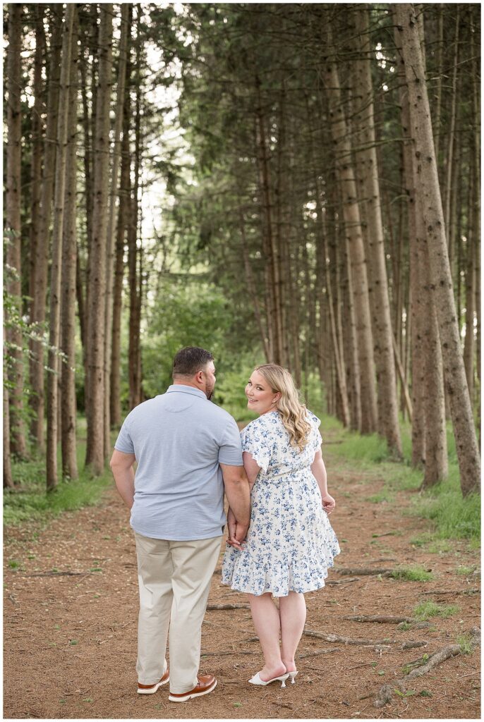 couple walking away from camera and girl looking over shoulder to camera during spring Overlook Park engagement session