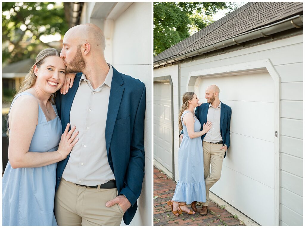 Engaged couple posing against a white painted building in Old Trinity Place Lancaster PA, man kissing woman's cheek as she laughs during their engagement session