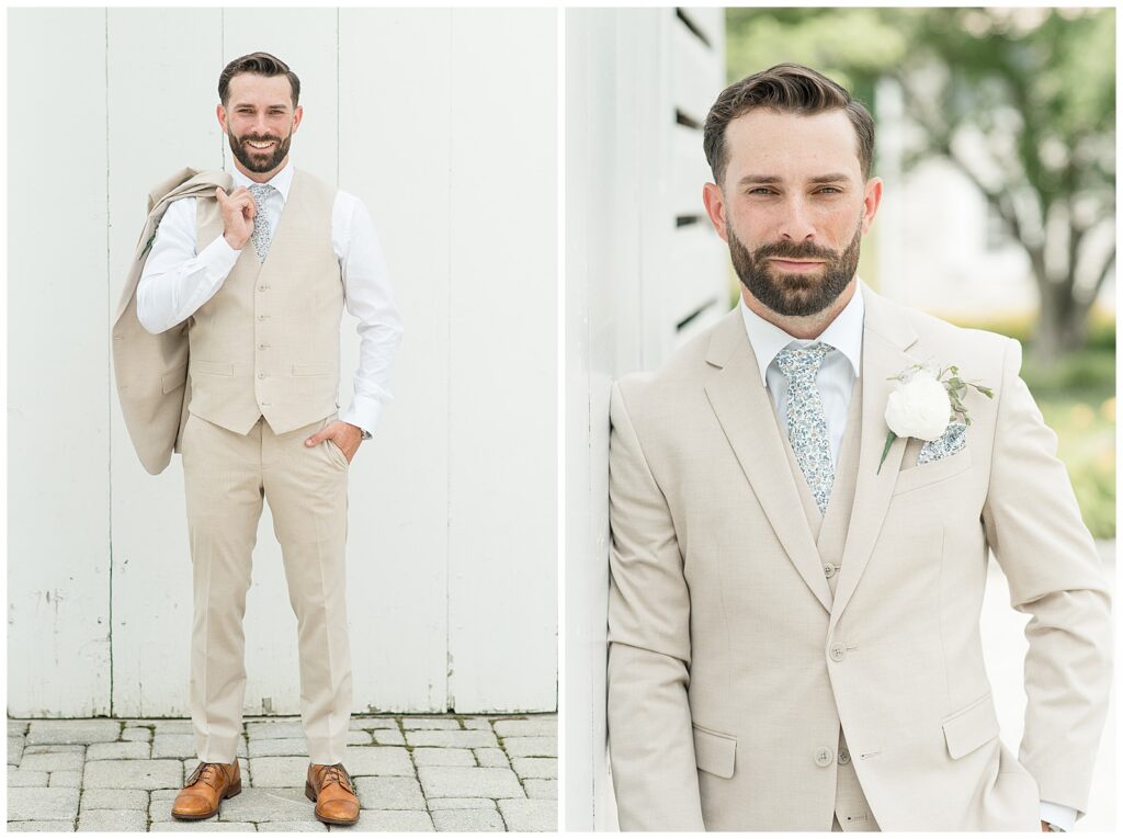 Groom smiling with his tan suit jacket over his shoulder during solo portraits at Bluestone Estate | Heather Marie Photography // Close-up portrait of groom leaning against the white barn wall at Bluestone Estate summer wedding | Heather Marie Photography