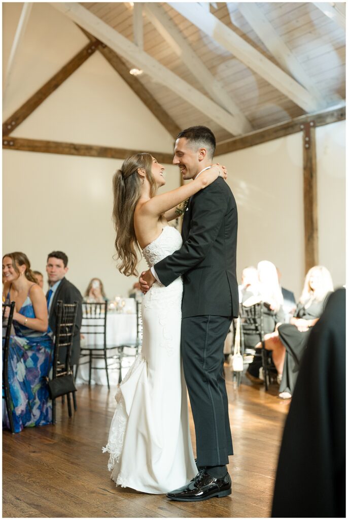 Bride and groom sharing first dance at Riverdale Manor summer wedding reception
